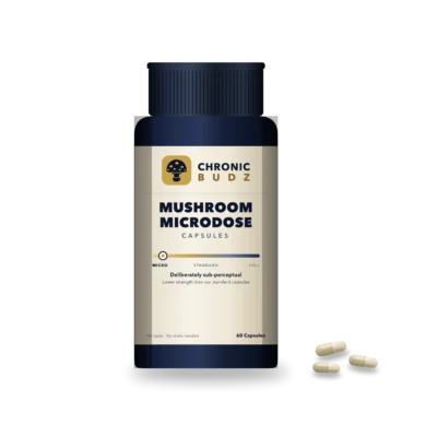 Mushroom microdose capsules in a navy bottle with capsules