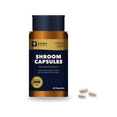 Shroom capsules in an amber bottle with capsules in front
